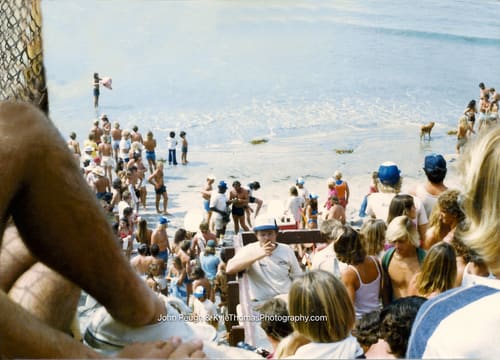 Two men at the microphone under the bluff