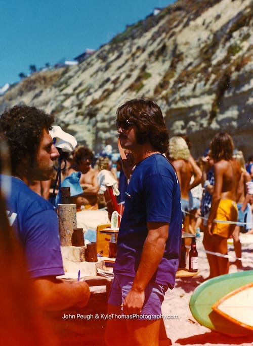 Standing in the shallows, the crowd behind