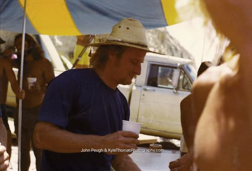 Navy shirt and straw hat under the awning
