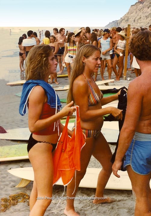 Two with boards and an orange towel