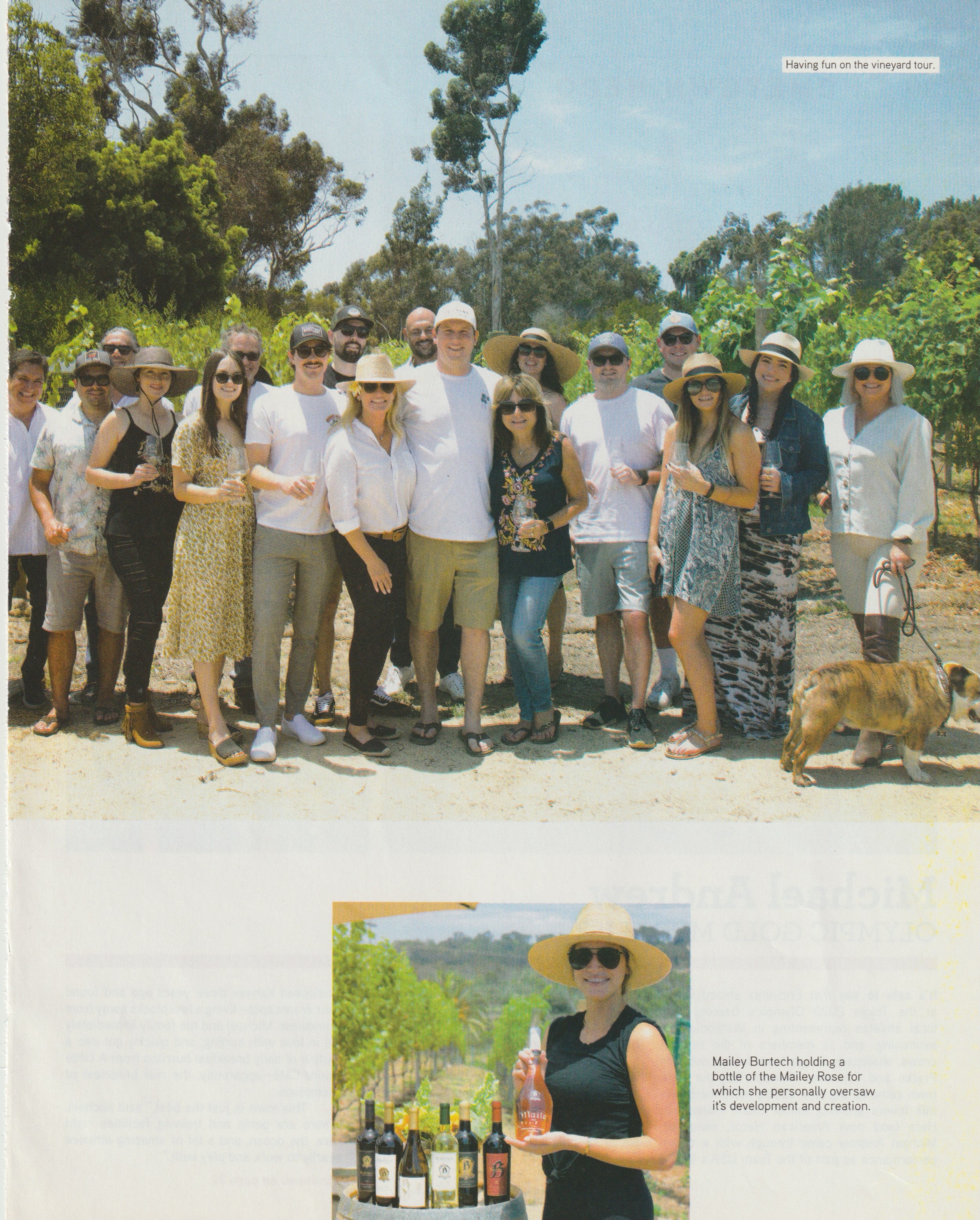 Page 29 of Encinitas Magazine, the vineyard tour group photograph above Maile Burtech holding a bottle of Maile Rosé beside a wine barrel