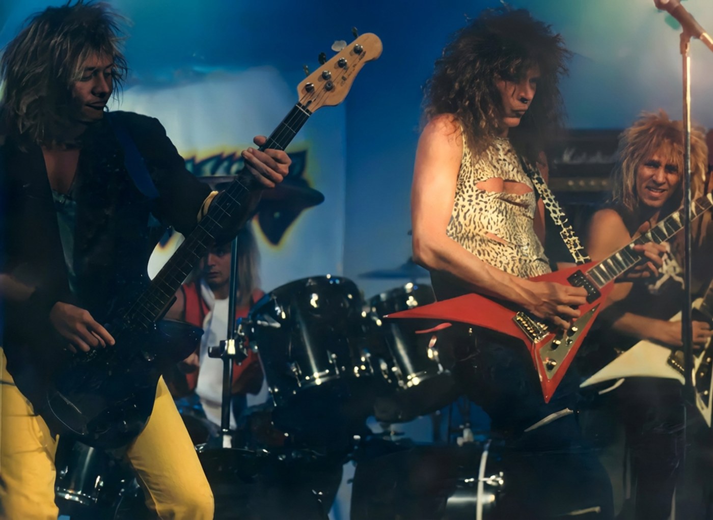Snakebyte performing live in colour, Wally Passet playing a red Flying V guitar