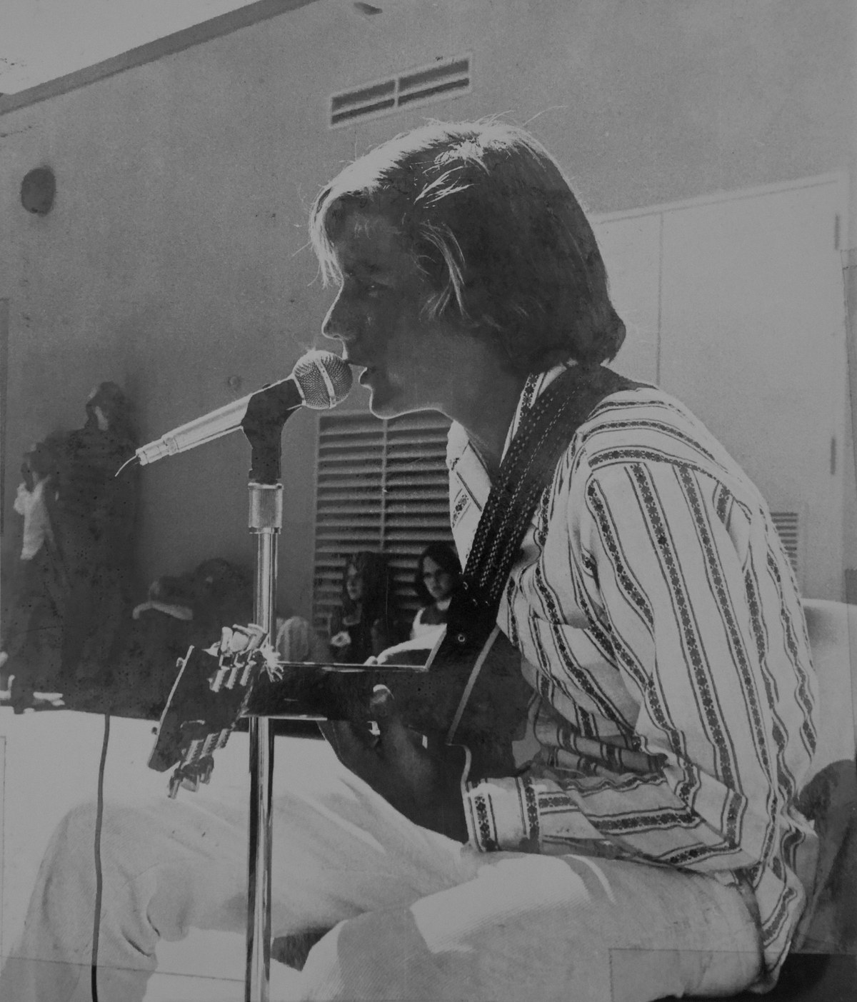 Wally Passet in seventh grade singing into a microphone with a guitar at Oak Crest Junior High