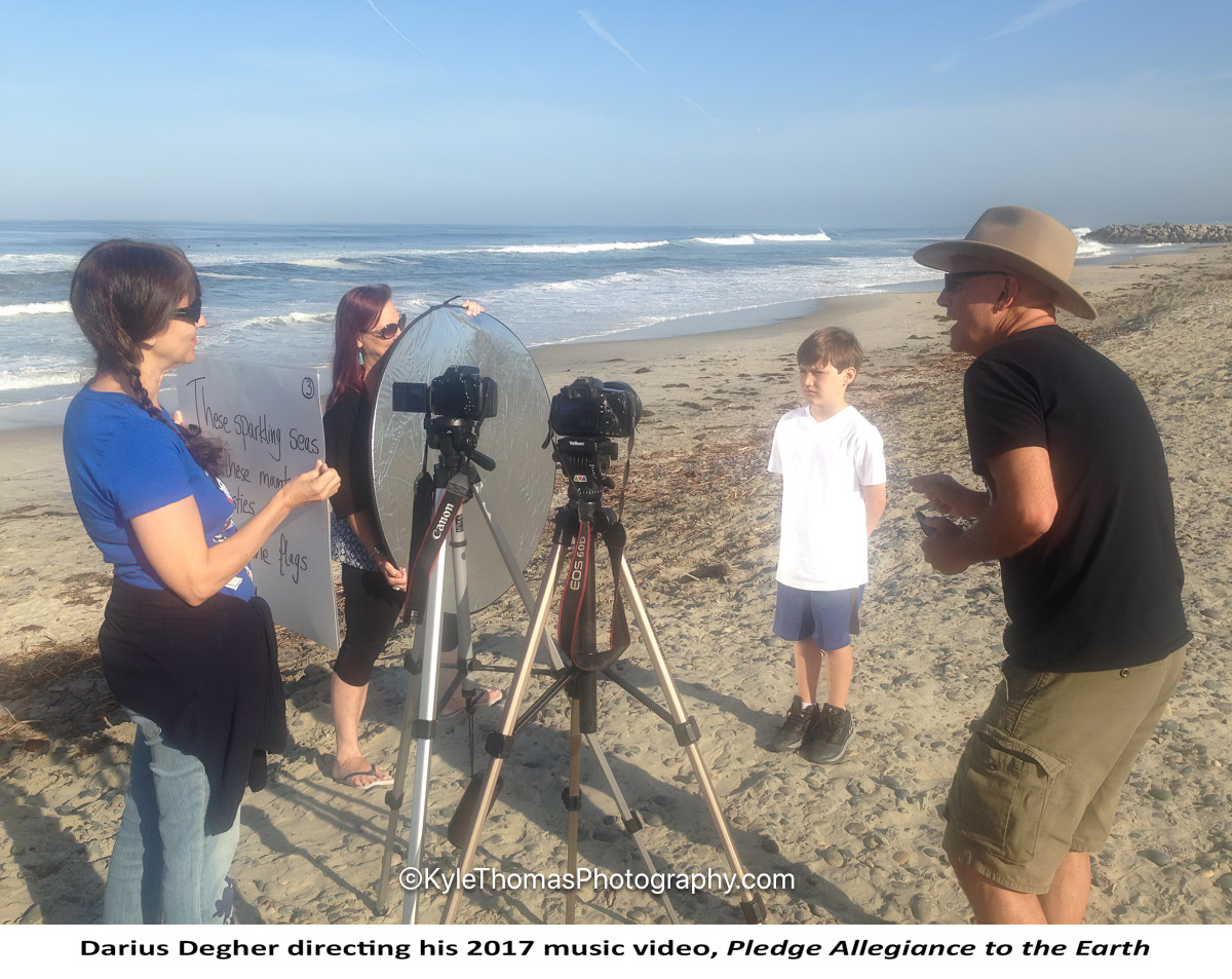 Darius Degher directing his 2017 music video, Pledge Allegiance to the Earth, on the beach