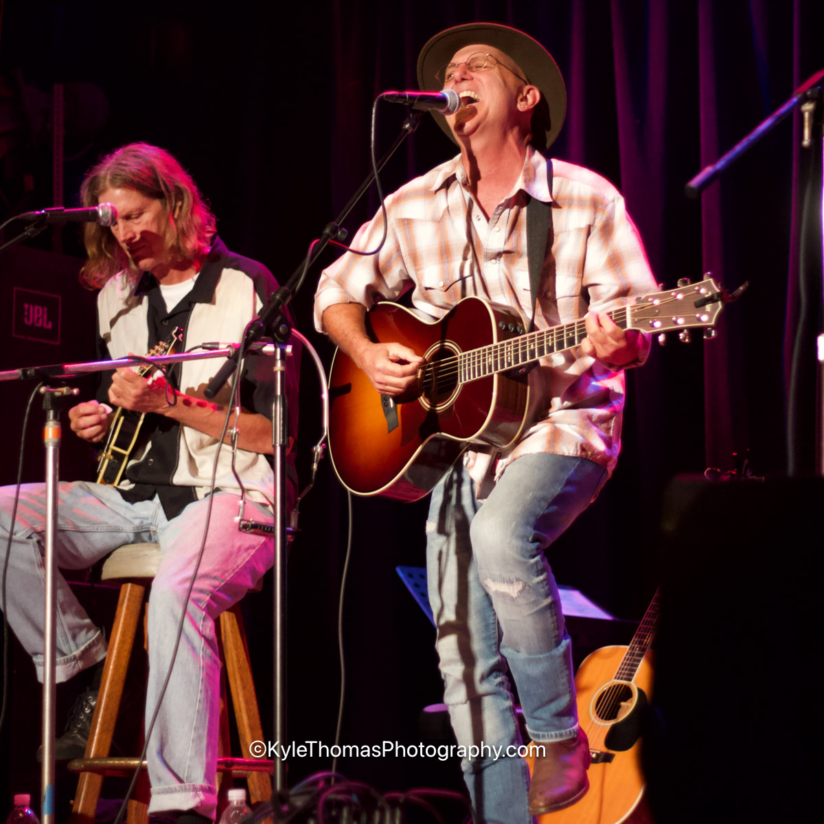 Darius Degher performing live on stage with a bandmate