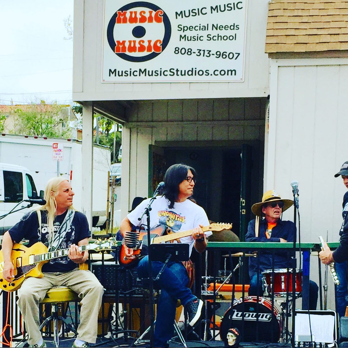 The Johnny Rock Band playing outside Music Music Studios in Encinitas, under the Music Music Special Needs Music School sign