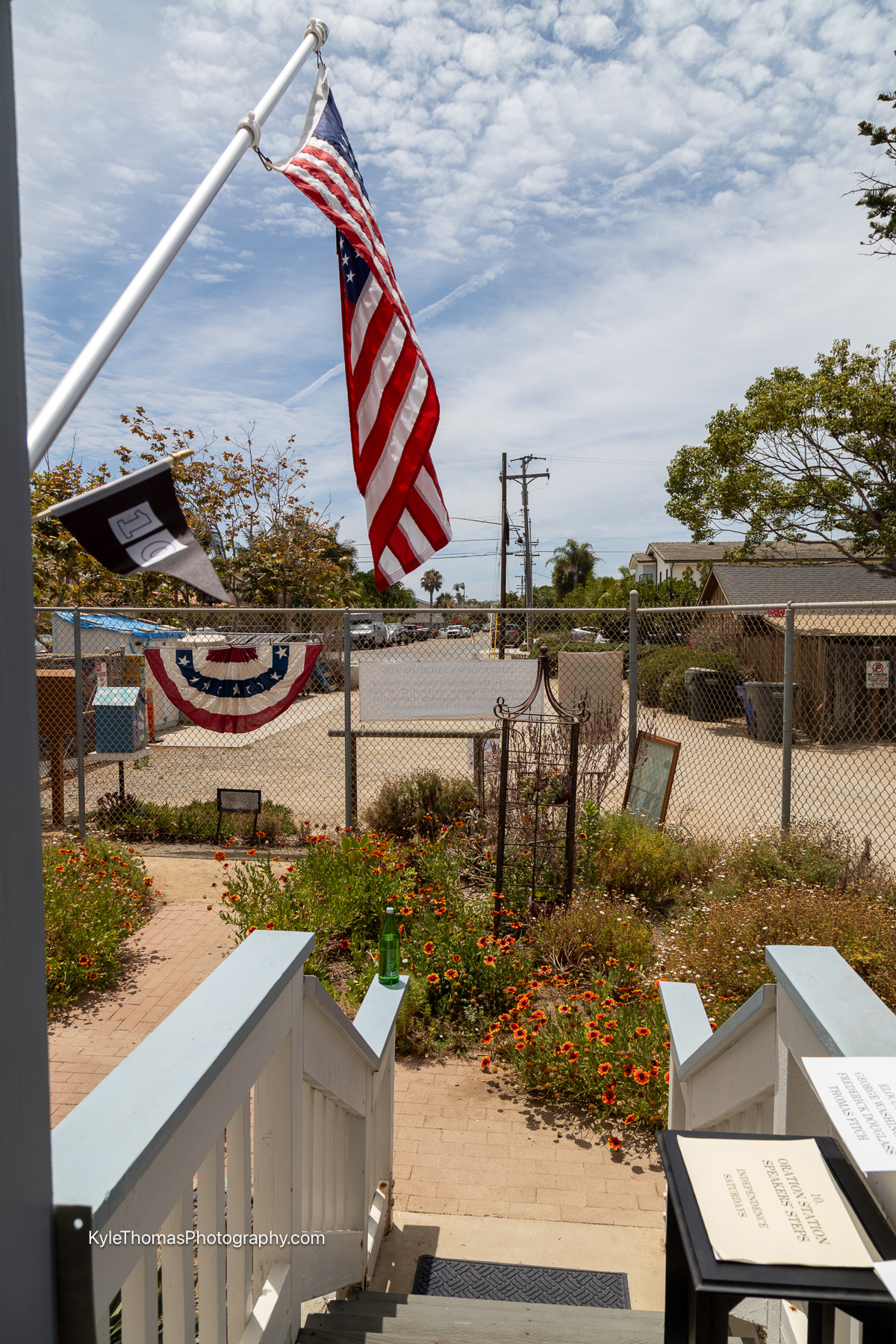 The flag hanging outside the back door of the 1883 Schoolhouse