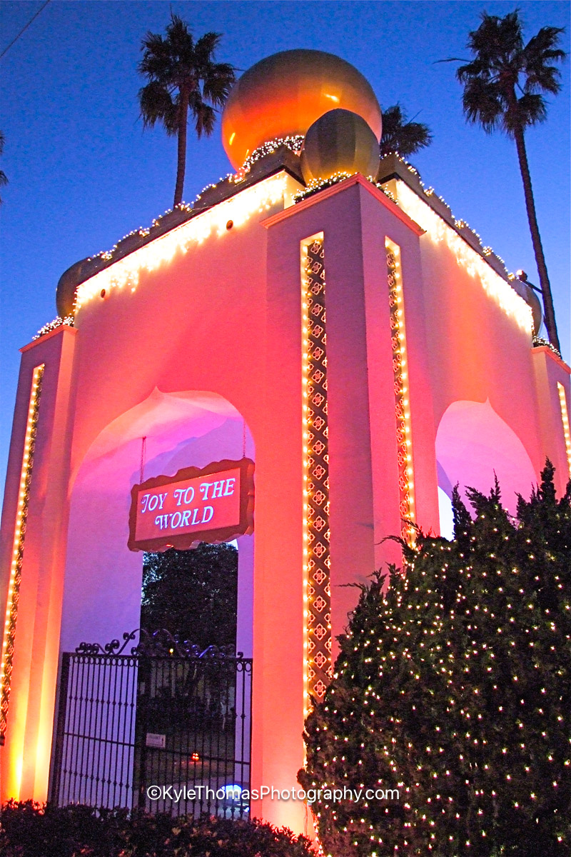The Self-Realization Fellowship golden lotus tower at Swamis strung with holiday lights and a Joy to the World sign, New Year's Eve, Encinitas California